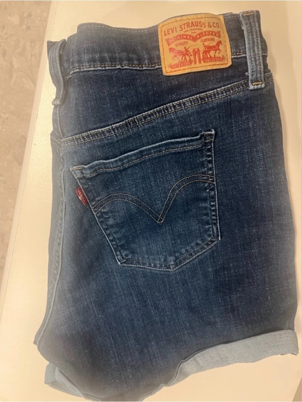 Levi's Dark Blue Denim with Tan Stitch Button Close-Up - Picture 4 of 9